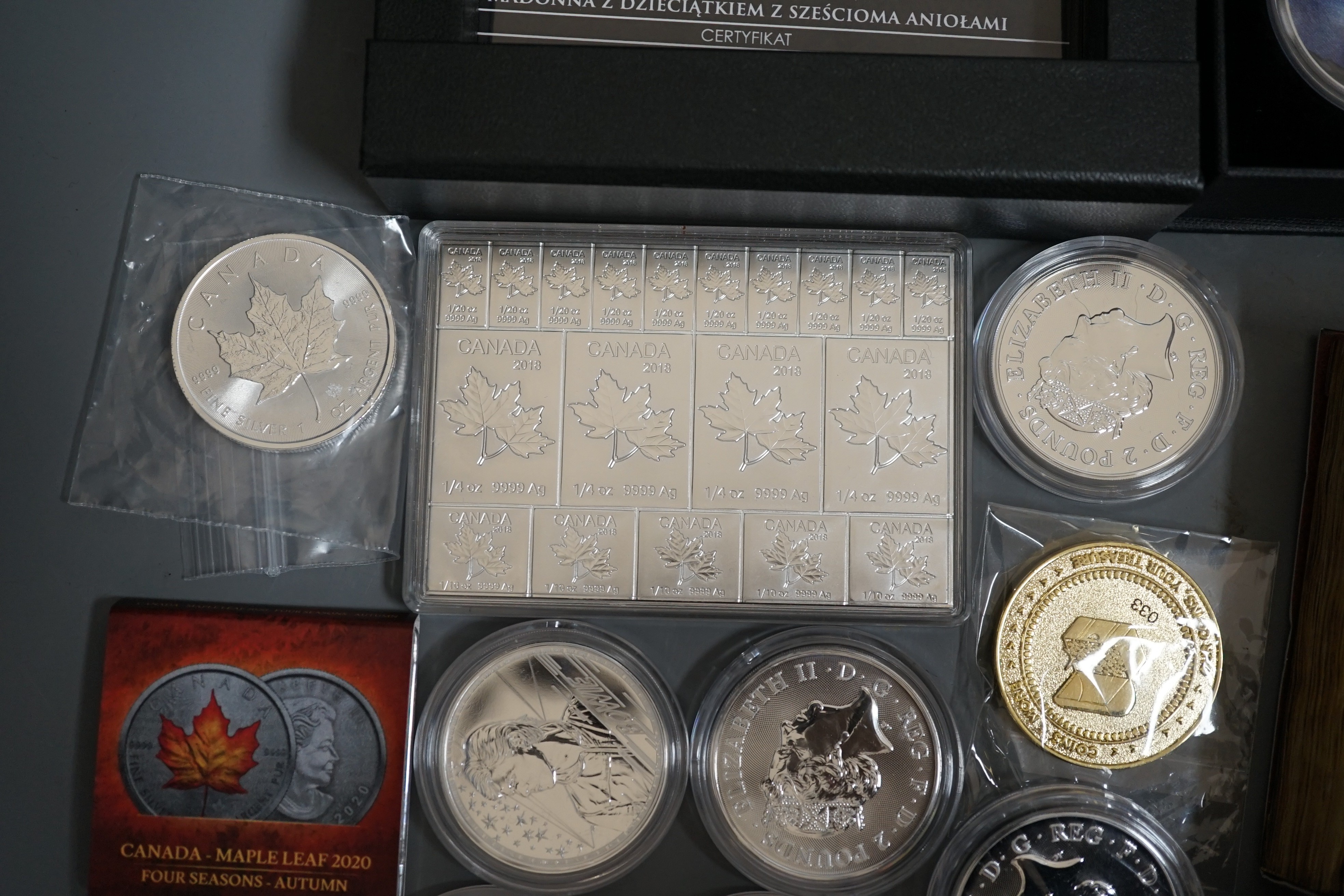 Ten bullion silver 1oz. commemorative coins, a bullion silver 2oz. coin and a Canada 2oz. silver ingot, BU